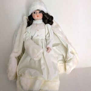 House of Lloyd 1988. Christmas Winter White Dress Doll . New in box with stand.